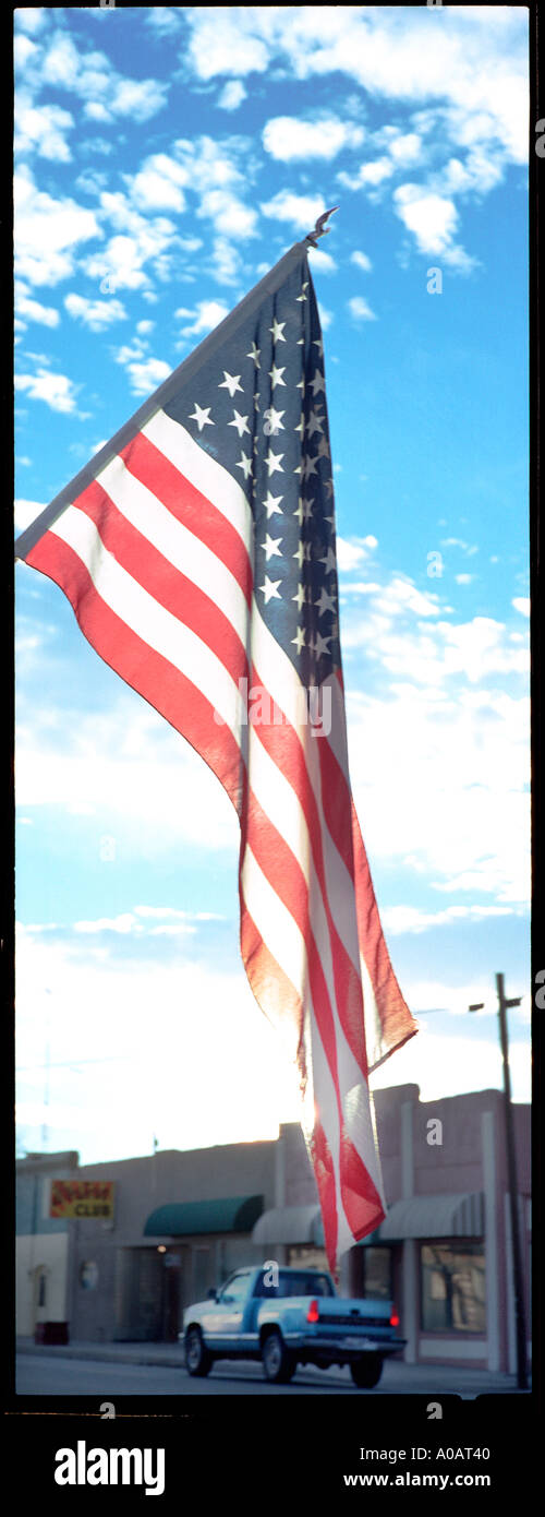 A panoramic vertical color image of an American flag backlit by the sun Stock Photo