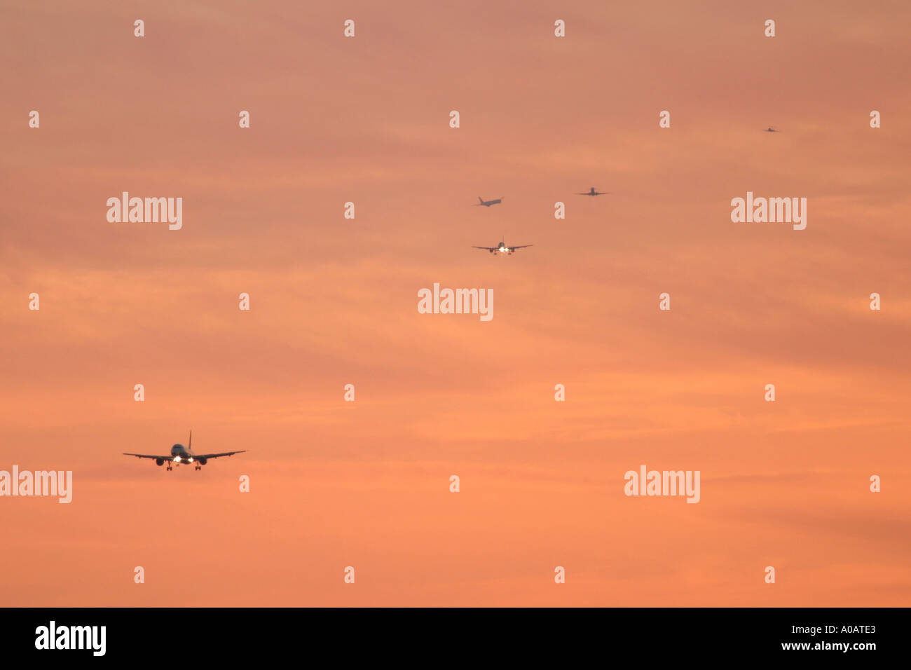 Commercial airplanes queue up to land hires stock photography and