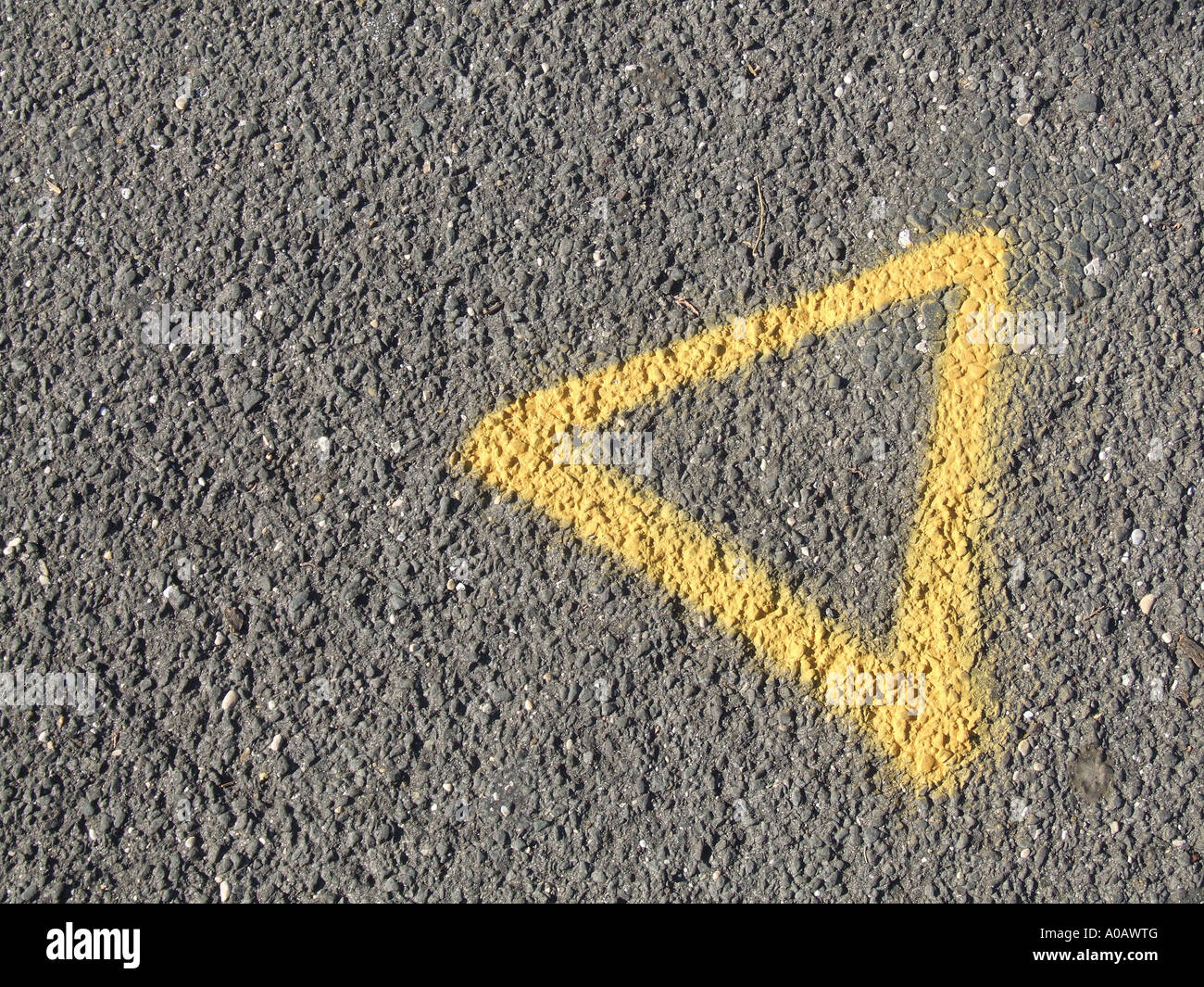 yellow triangle painted on road Stock Photo Alamy