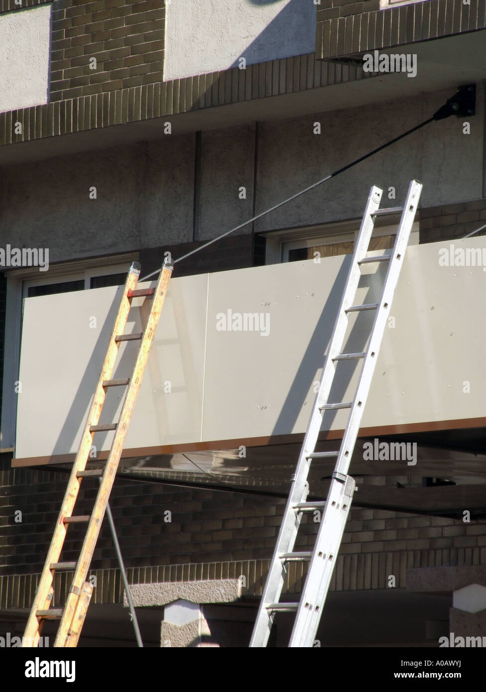 two ladders on building Stock Photo Alamy