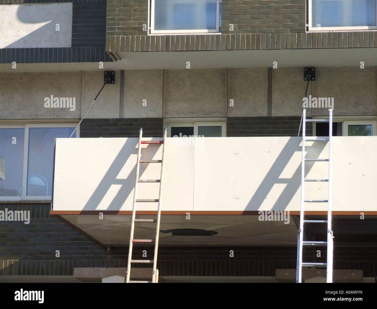 two ladders on building Stock Photo Alamy