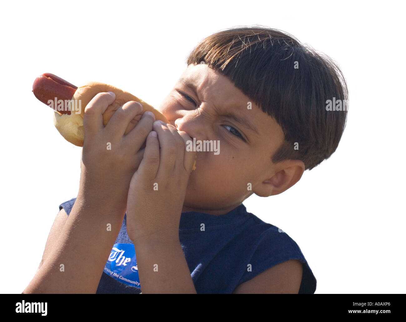 Latino boy eating hot dog Stock Photo