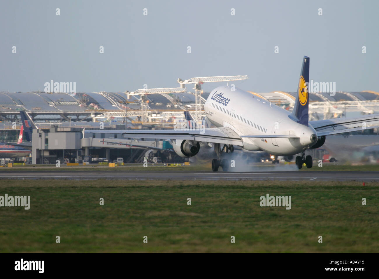 Lufthansa Airbus A320 211 D-AIPF touching down at London Heathrow. In the background visible constructing work of new Terminal 5 Stock Photo