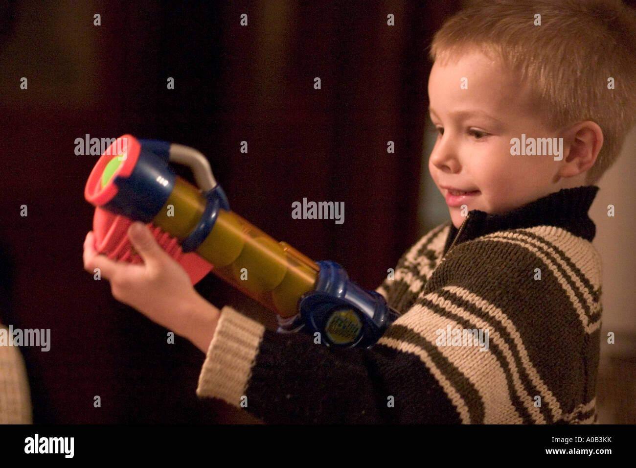 Boy age 5 playing with his new Christmas automatic Nerf gun. Plymouth Minnesota MN USA Stock Photo