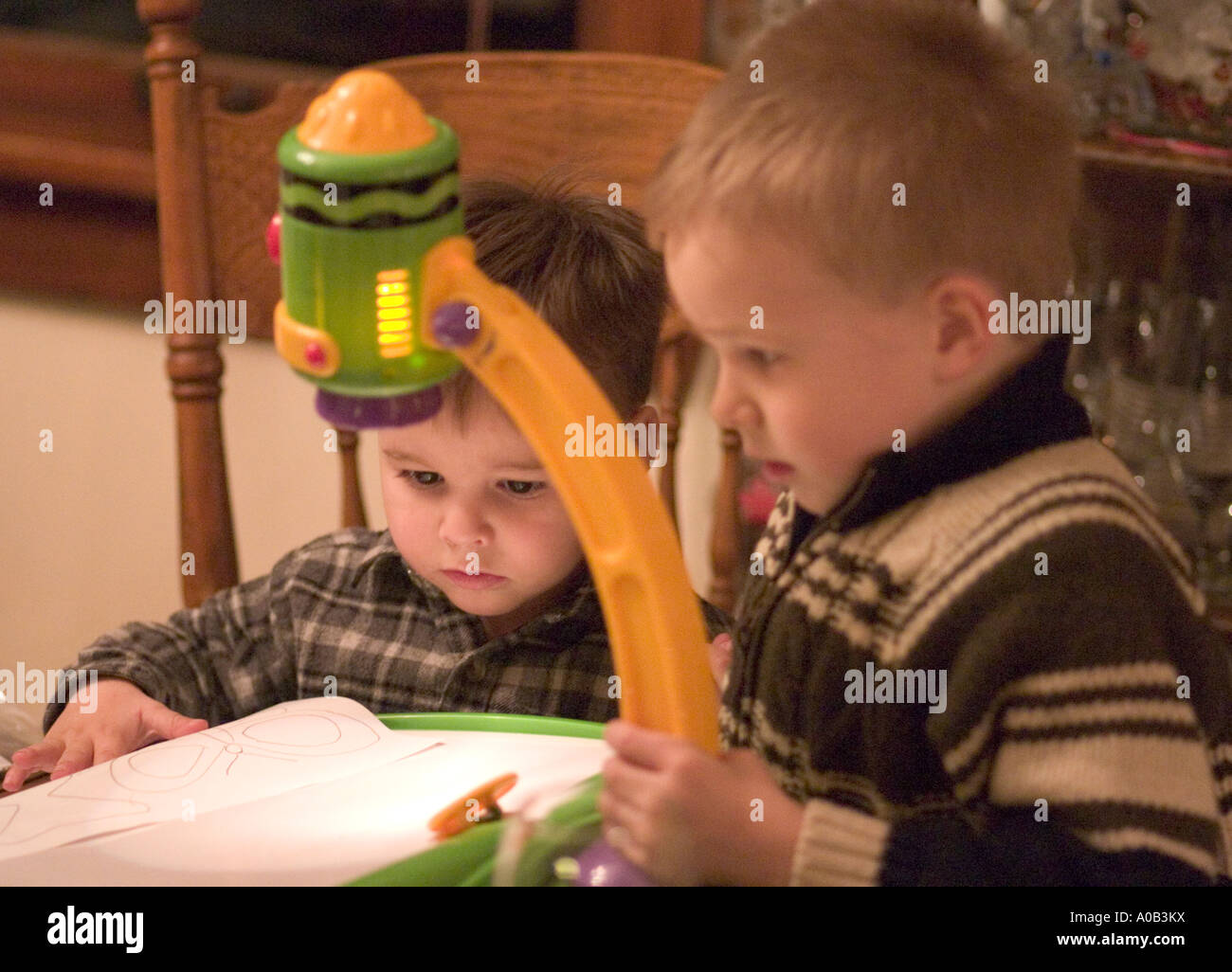 Brothers age 2 and 5 operating Crayola Trace-N-Draw Projector. Plymouth  Minnesota MN USA Stock Photo - Alamy