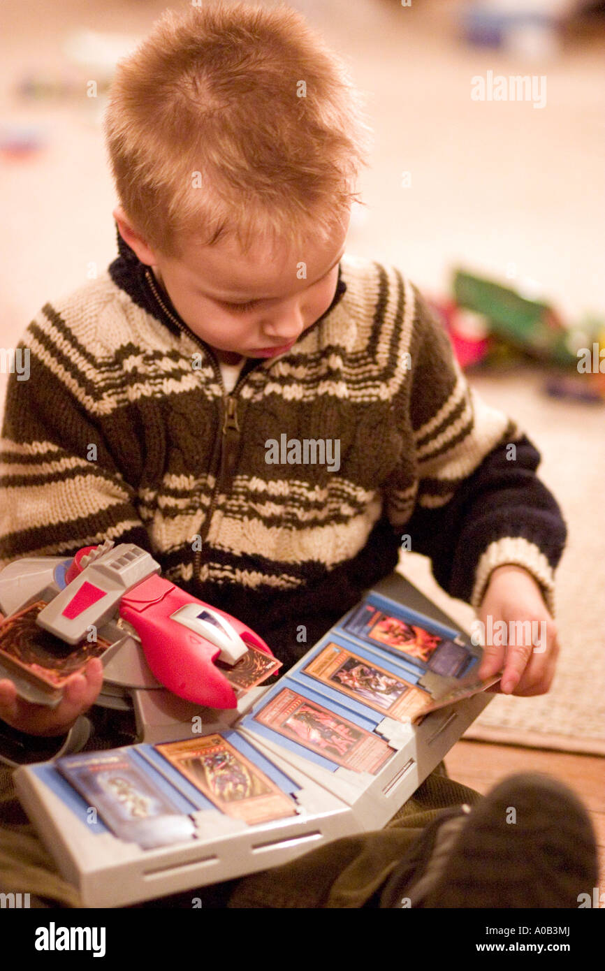 Boy age 5 loading his Yu-Gi-Oh Duel Disk Launcher. Plymouth Minnesota MN USA Stock Photo