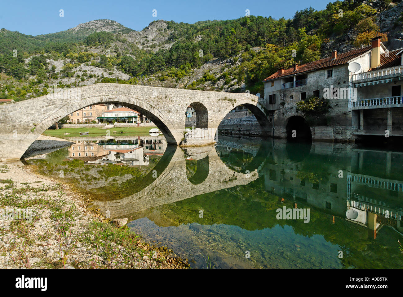 historic stone bridge in Rijeka Crnojevica at Skutari lake Montenegro Stock Photo