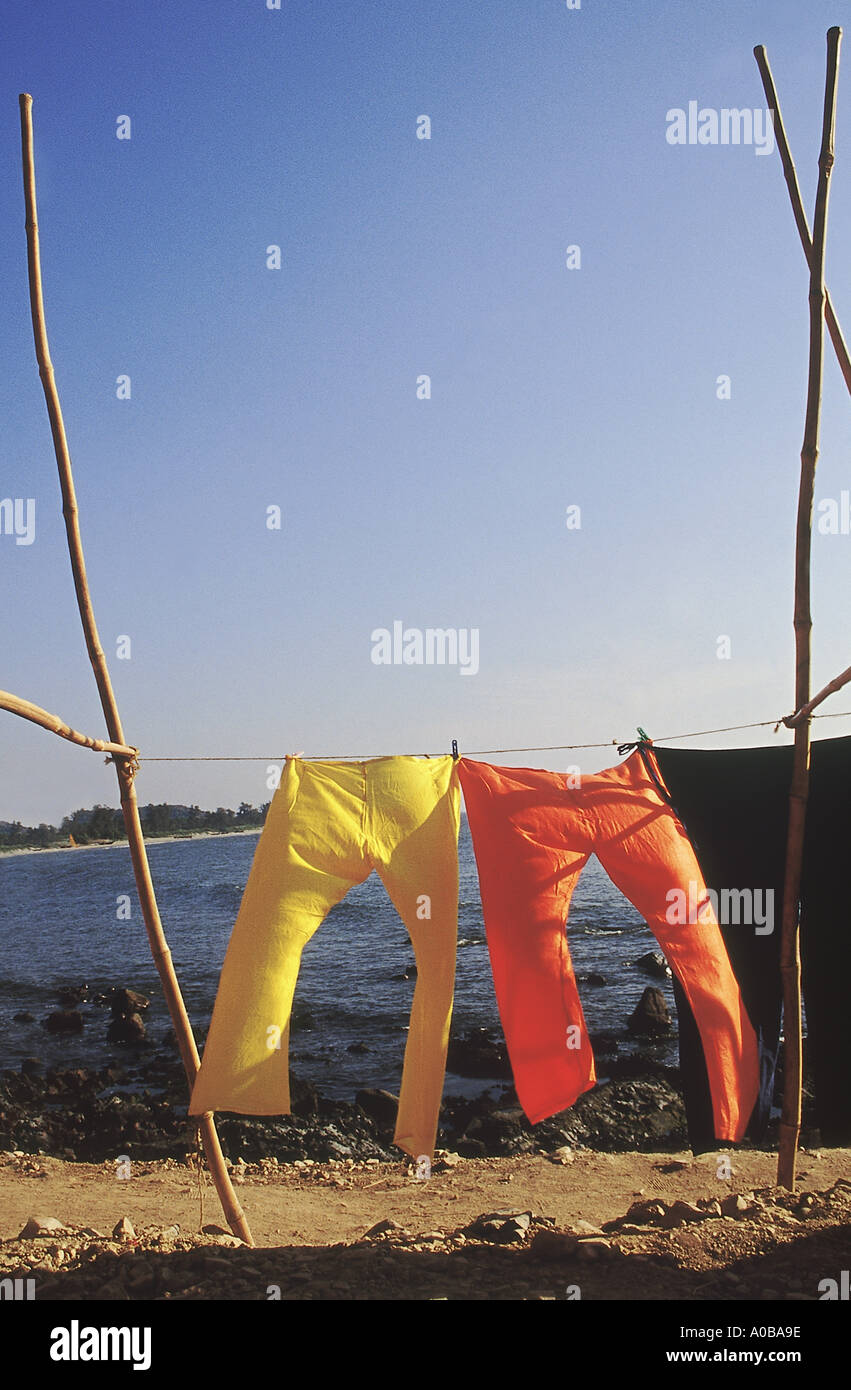 Bright trousers hanging out to dry on the seashore. Stock Photo