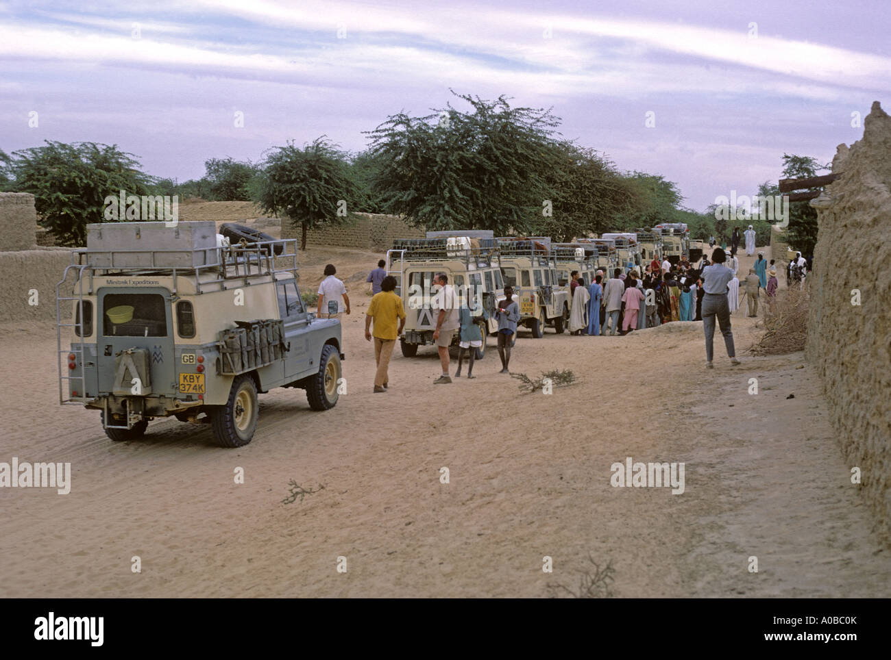 0238 06 Land Rovers at a village south of Gao Mali The Land Rover at the rear is a one ton model the rest are Series III Stock Photo