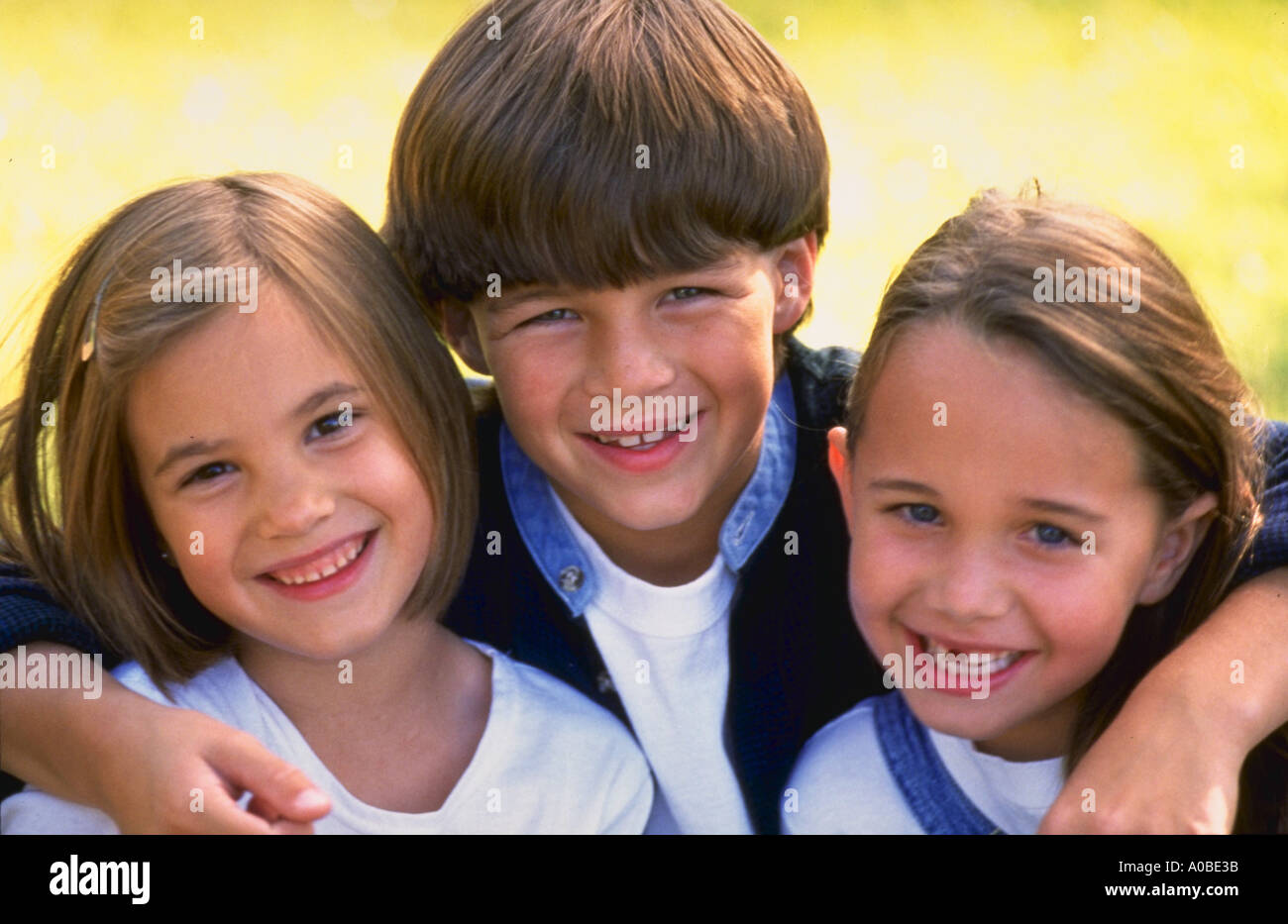 Portrait of two girls and a boy smiling Stock Photo - Alamy