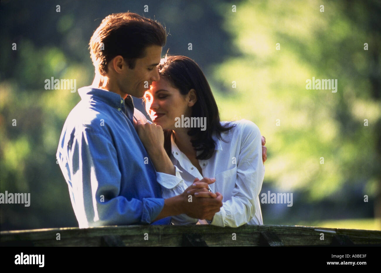 Man and woman holding hands and embracing outdoors Stock Photo