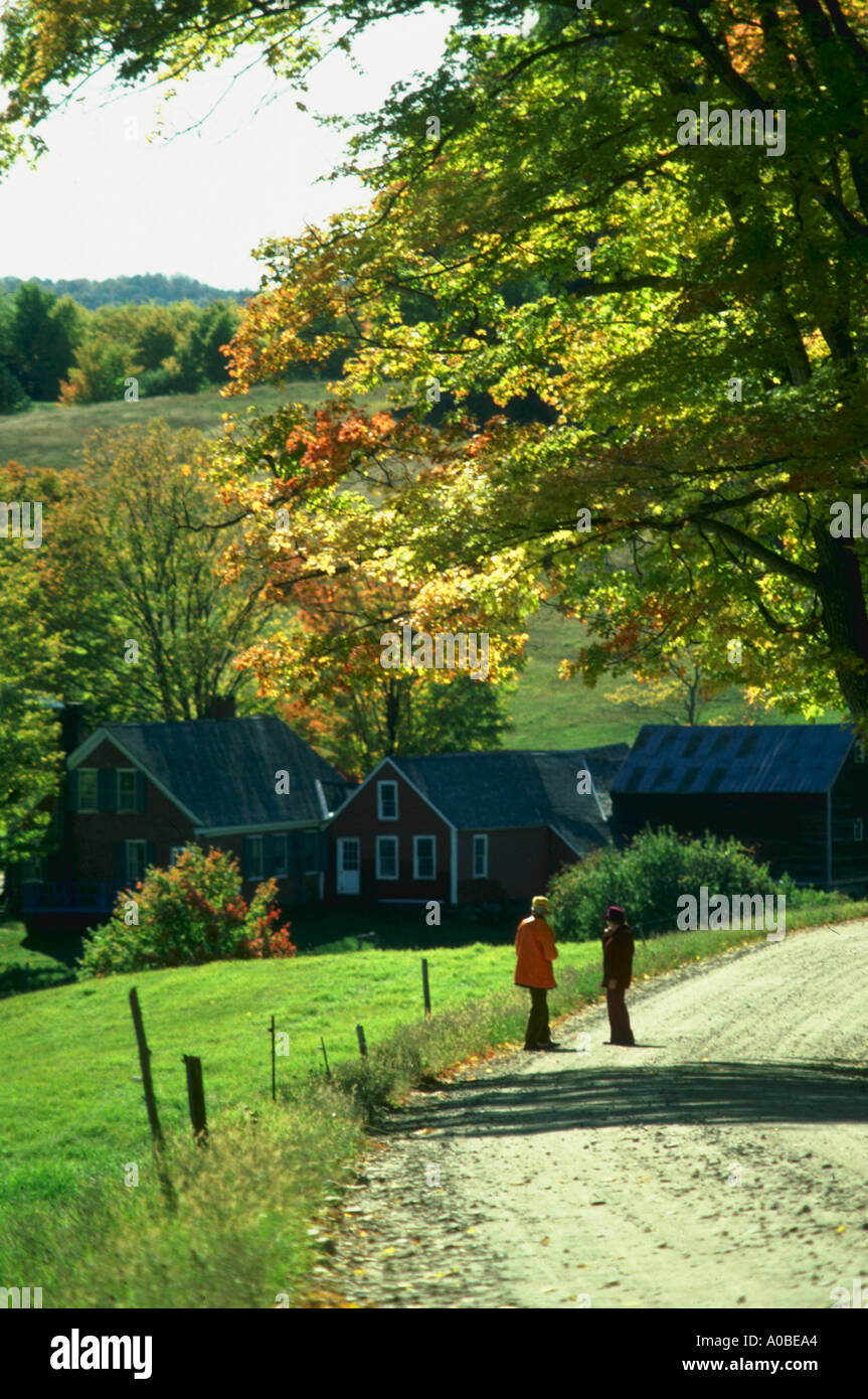 Senior couple walk along country road near Woodstock Vermont Stock Photo