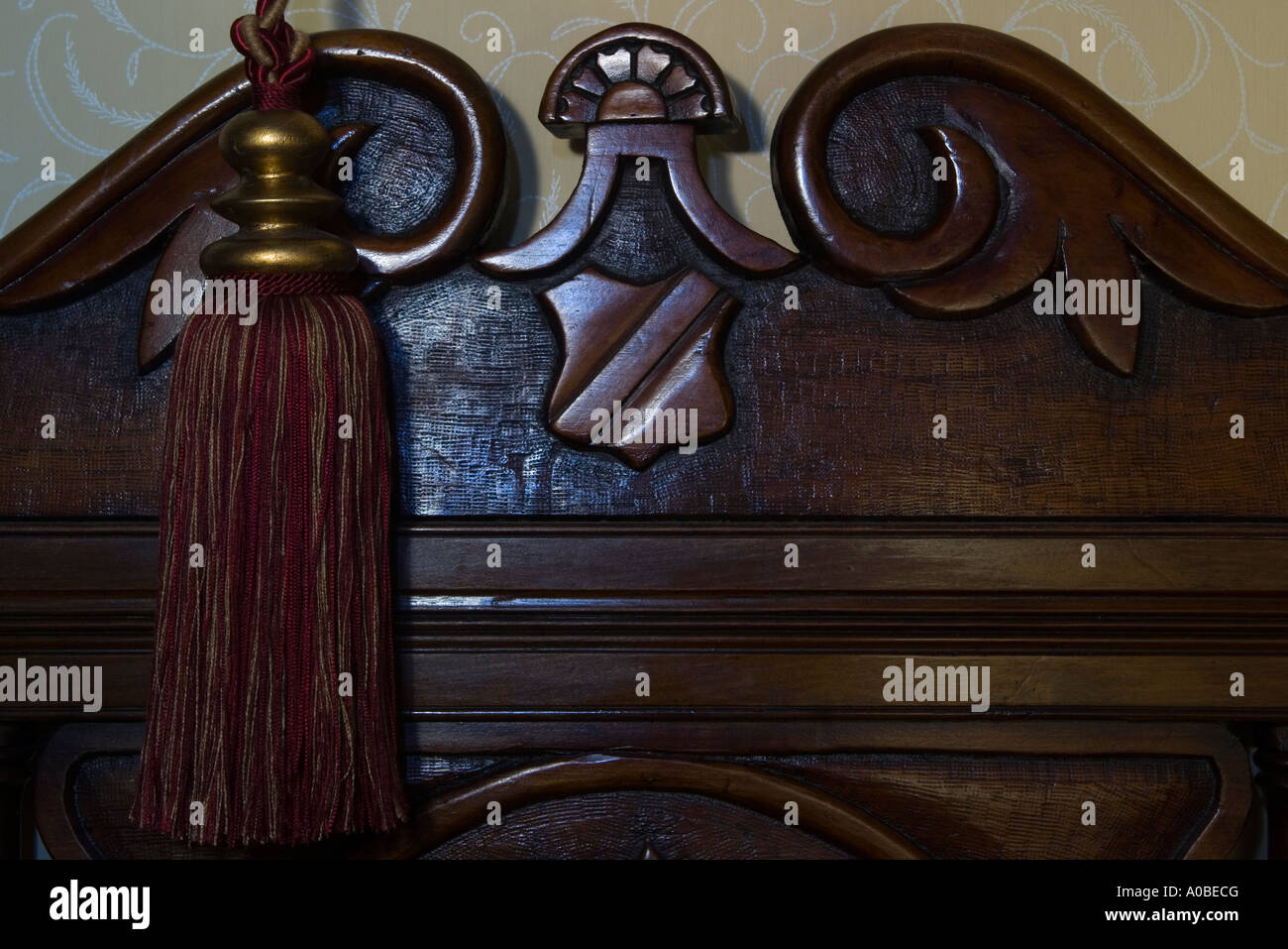 Carved wooden bedhead and tassle Stock Photo Alamy