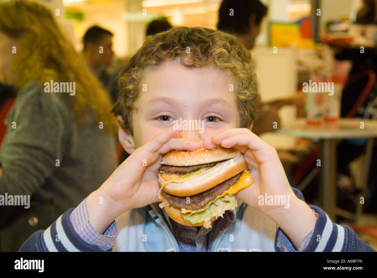 Child eating McDonald's Big Mac hamburger England UK Stock Photo Alamy