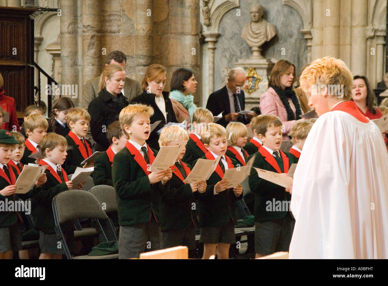 School boys singing hymn at a church service in Westminster Abbey London England UK Stock Photo