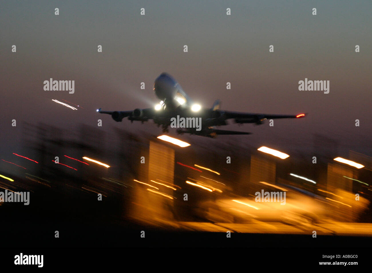 Airliner taking off at night Stock Photo