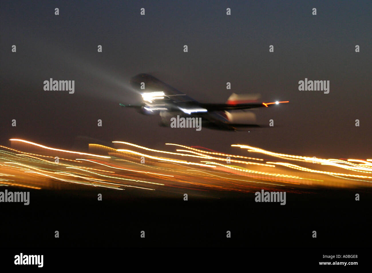 Airliner taking off at night Stock Photo