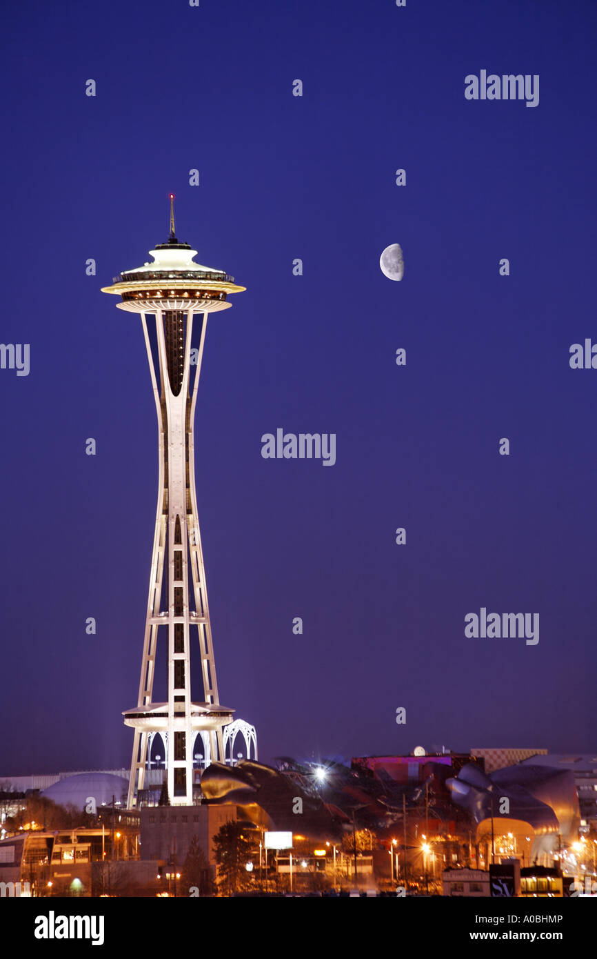 The Seattle Space Needle stands under a quarter moon in a twilight sky
