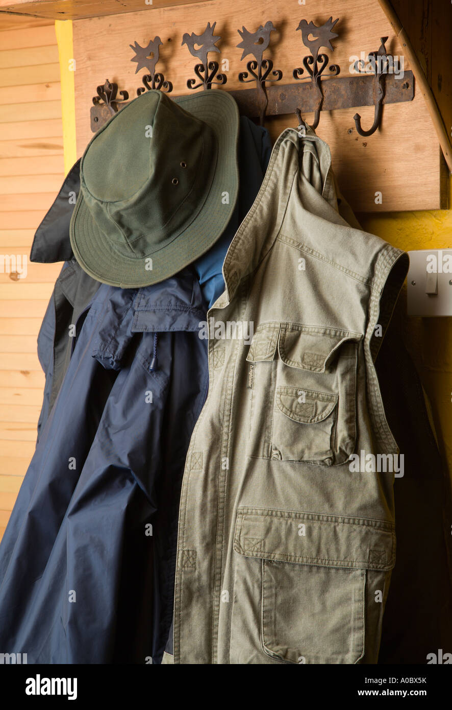 Coat rack with coats and hat in a country cottage Stock Photo