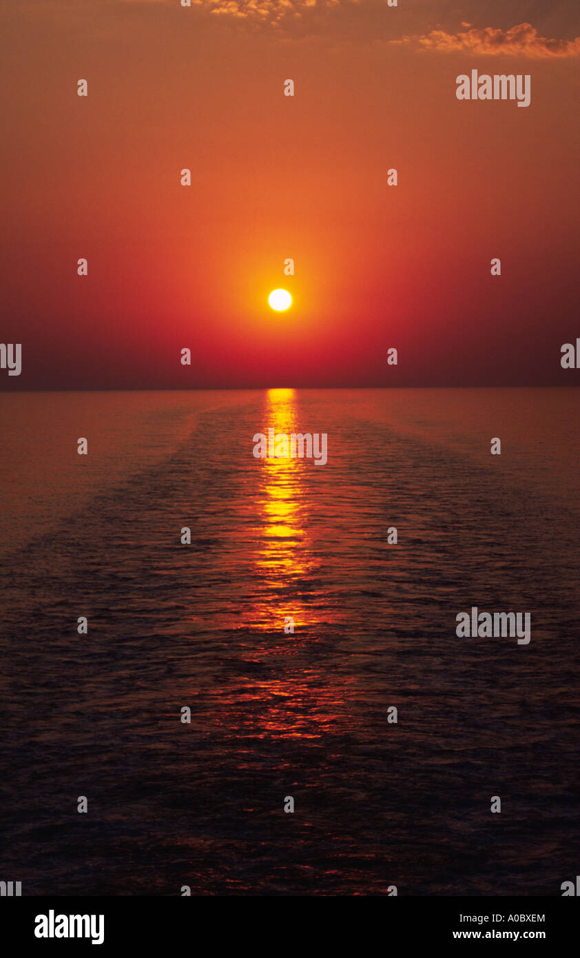 The setting sun on the Adriatic Sea, viewed from the stern of the Greek Ventouris ferry Siren Stock Photo