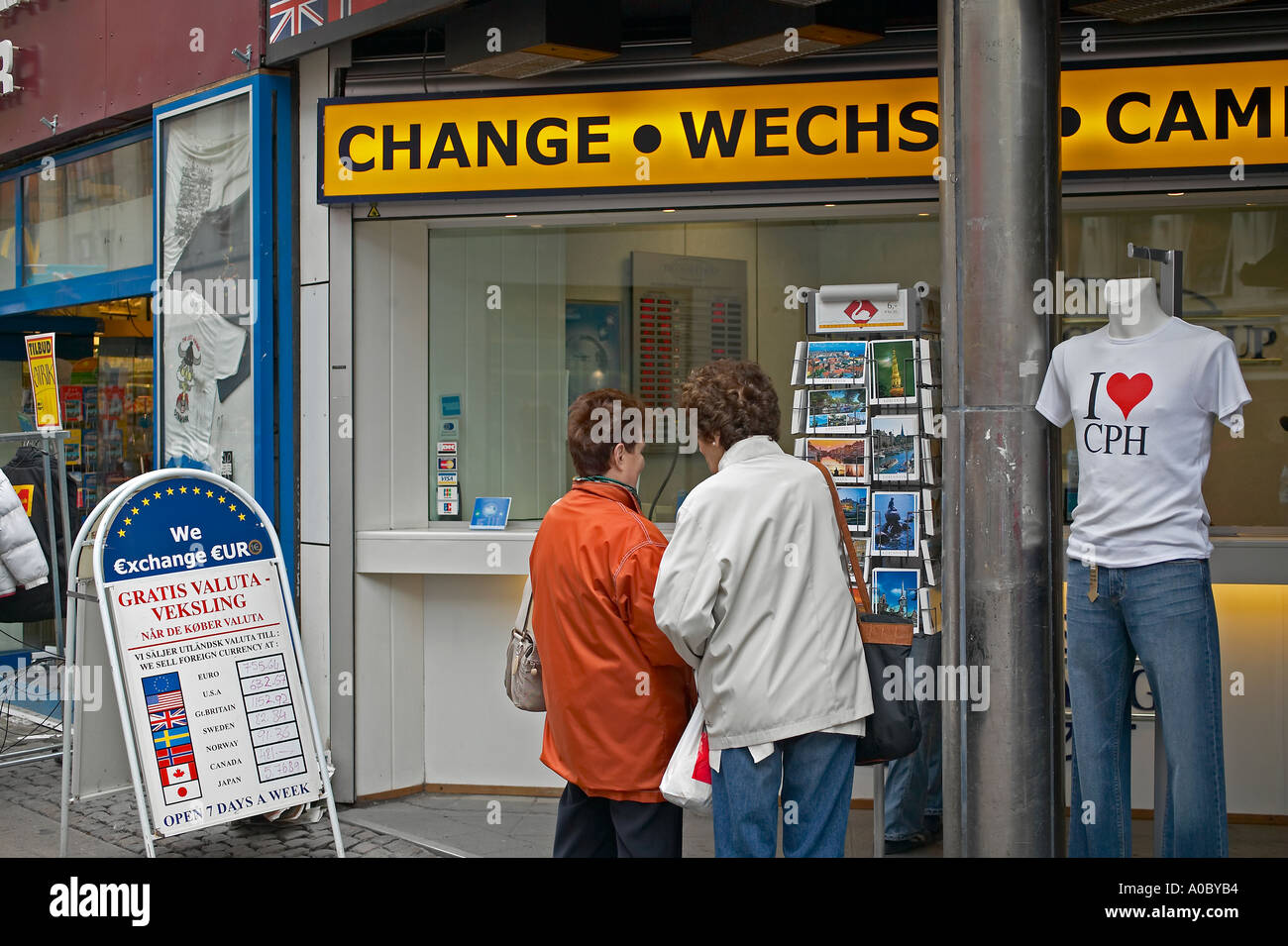 Two women shopping for postcards and bureau de change, Strøget shopping street, Copenhagen, Denmark Stock Photo