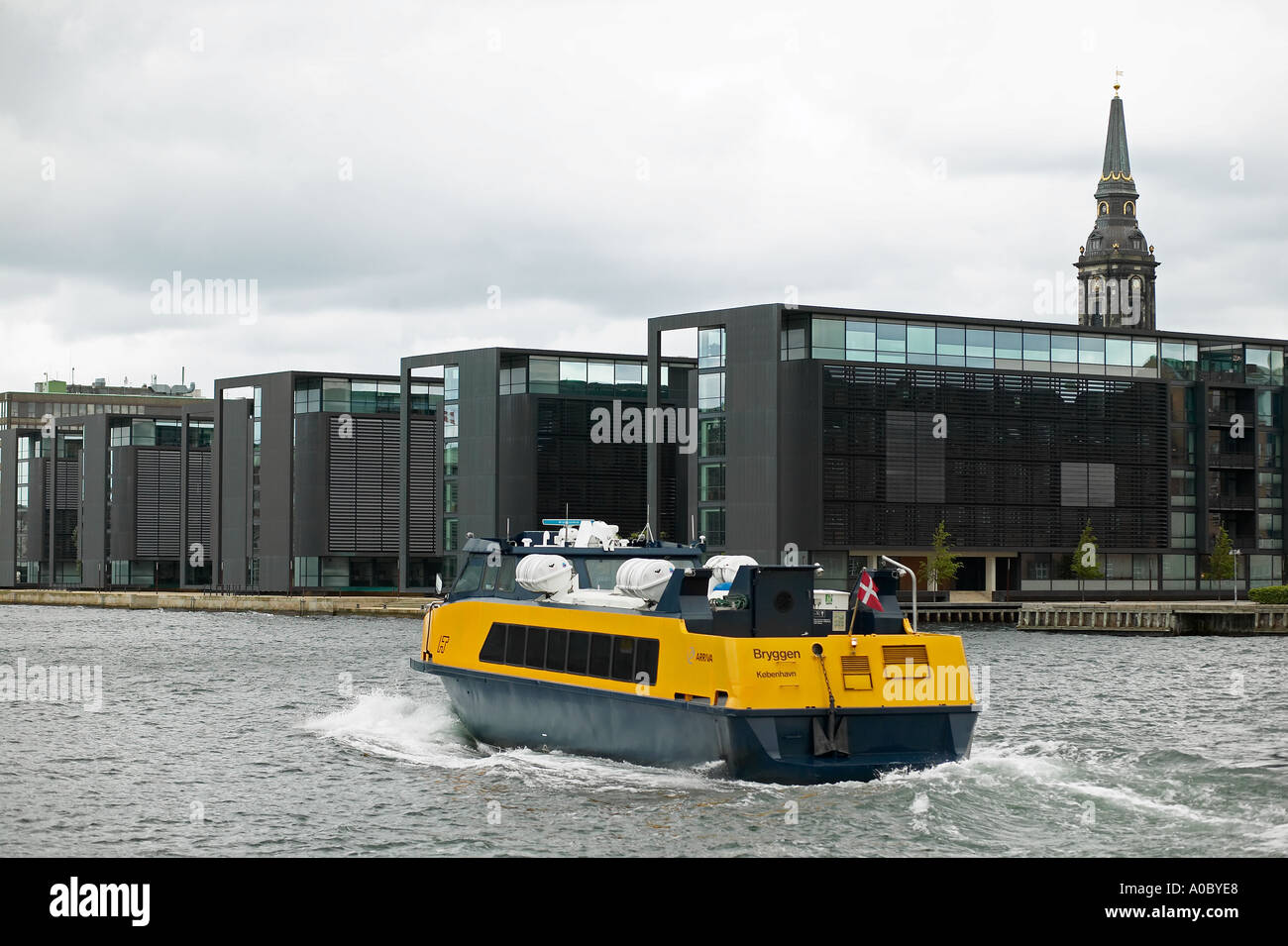 Yellow waterbus on Christianhavn canal and Nordea Bank headquarters, Copenhagen, Denmark, Europe Stock Photo