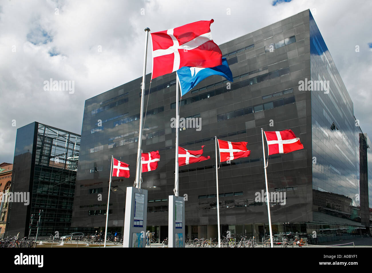 Danish flags and 'Black Diamond' Royal Library building, Copenhagen, Denmark Stock Photo