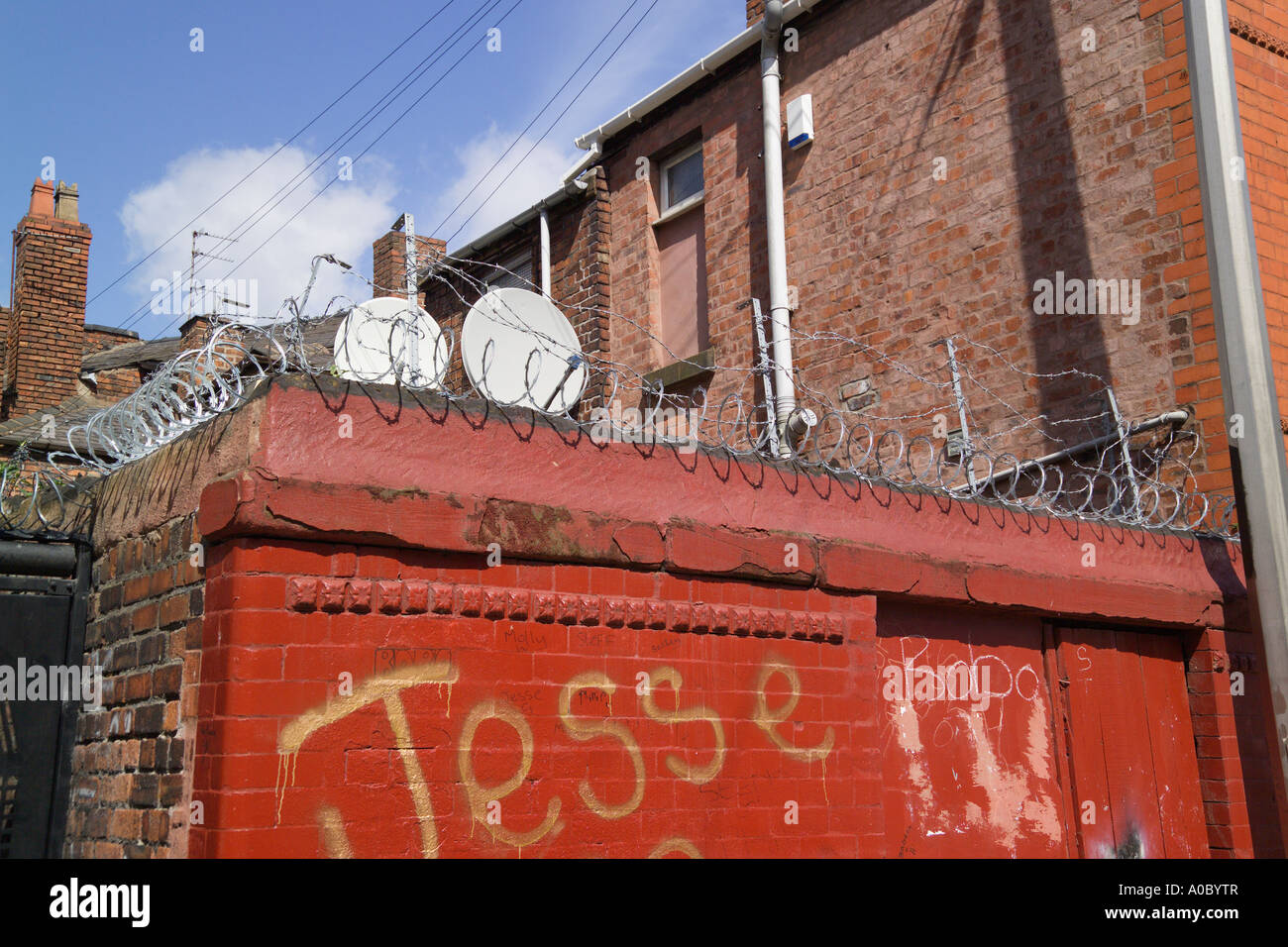 Barbed Wire on top of brick walls Anfield Liverpool Merseyside England Stock Photo