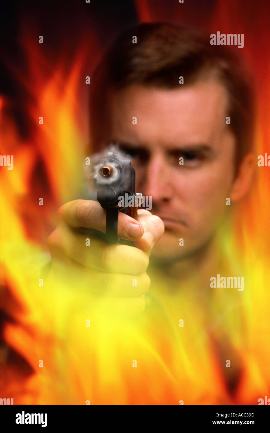 Man firing gun through flames Stock Photo Alamy