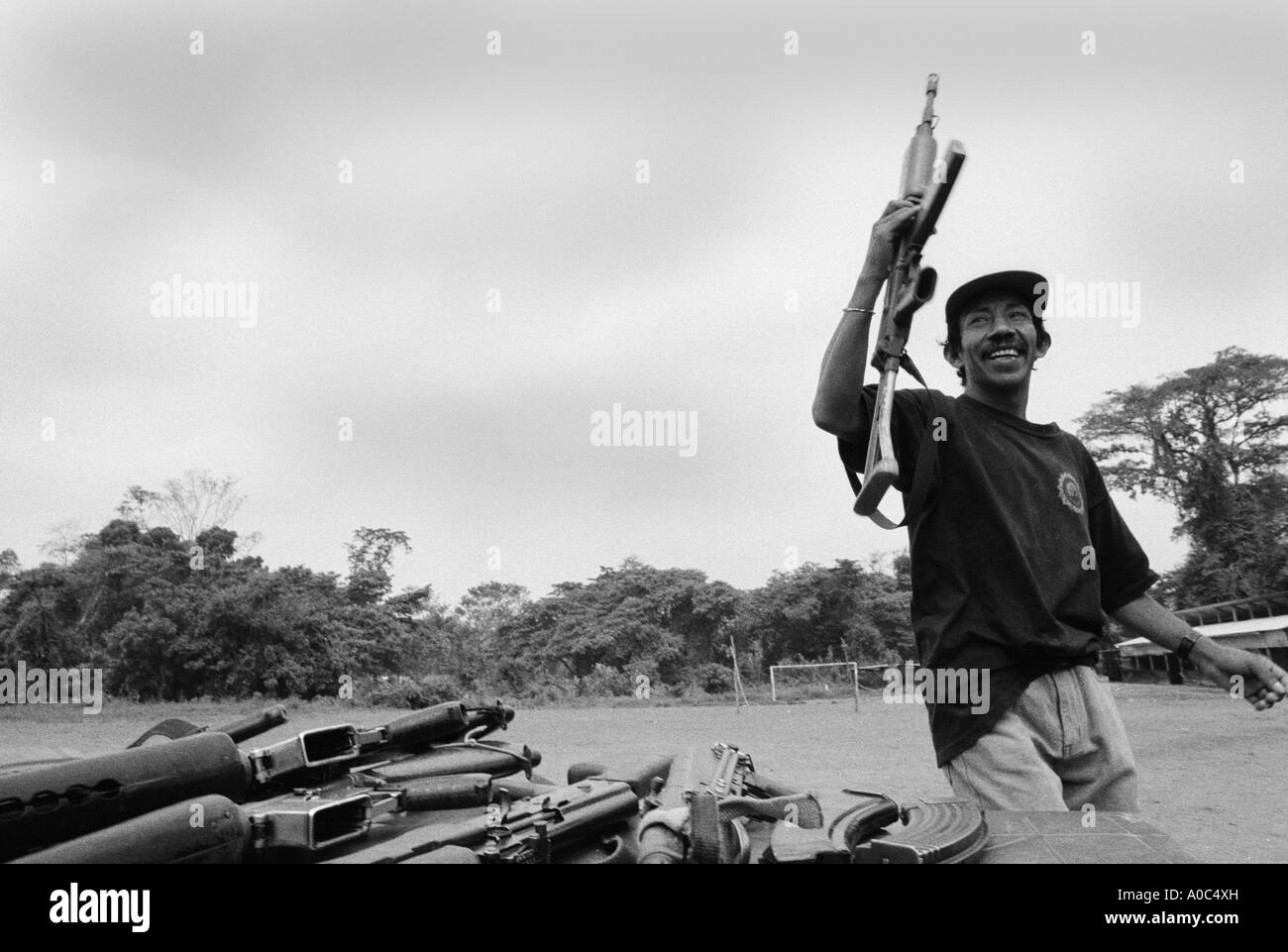 Stock image of a URNG guerrilla laying down his arms at demobilization Stock Photo