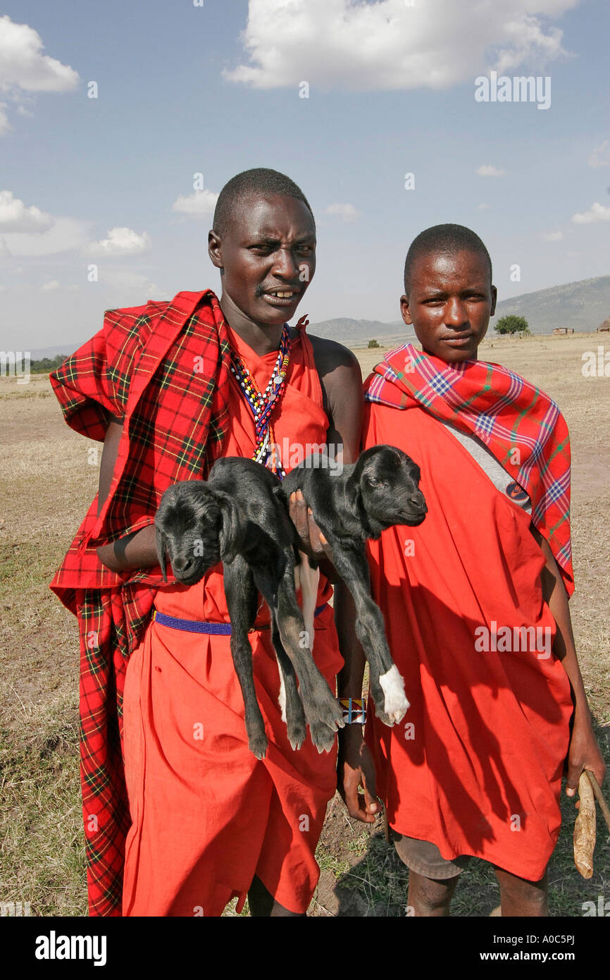 Maasai man and boy with baby goats Stock Photo