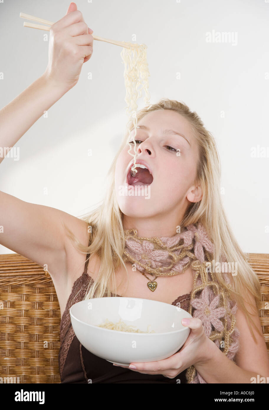 Woman eating noodles Stock Photo