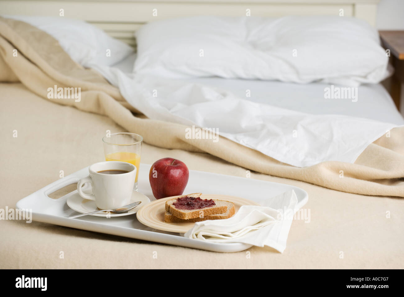 Still life of breakfast tray on bed Stock Photo