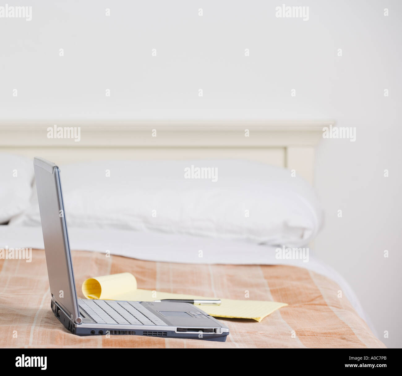 Still life of laptop computer on bed Stock Photo Alamy