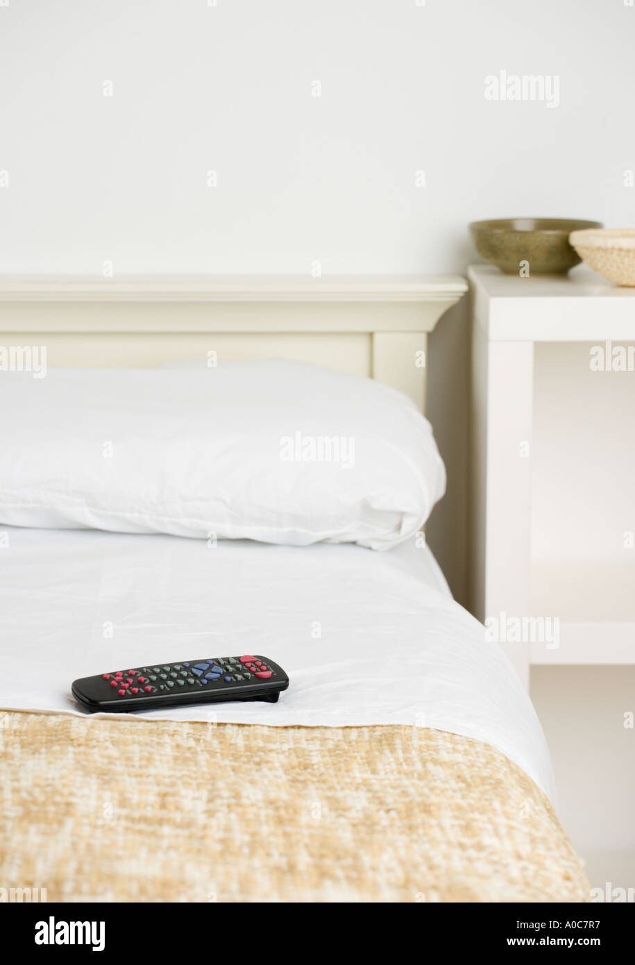 Still life of remote control on bed Stock Photo