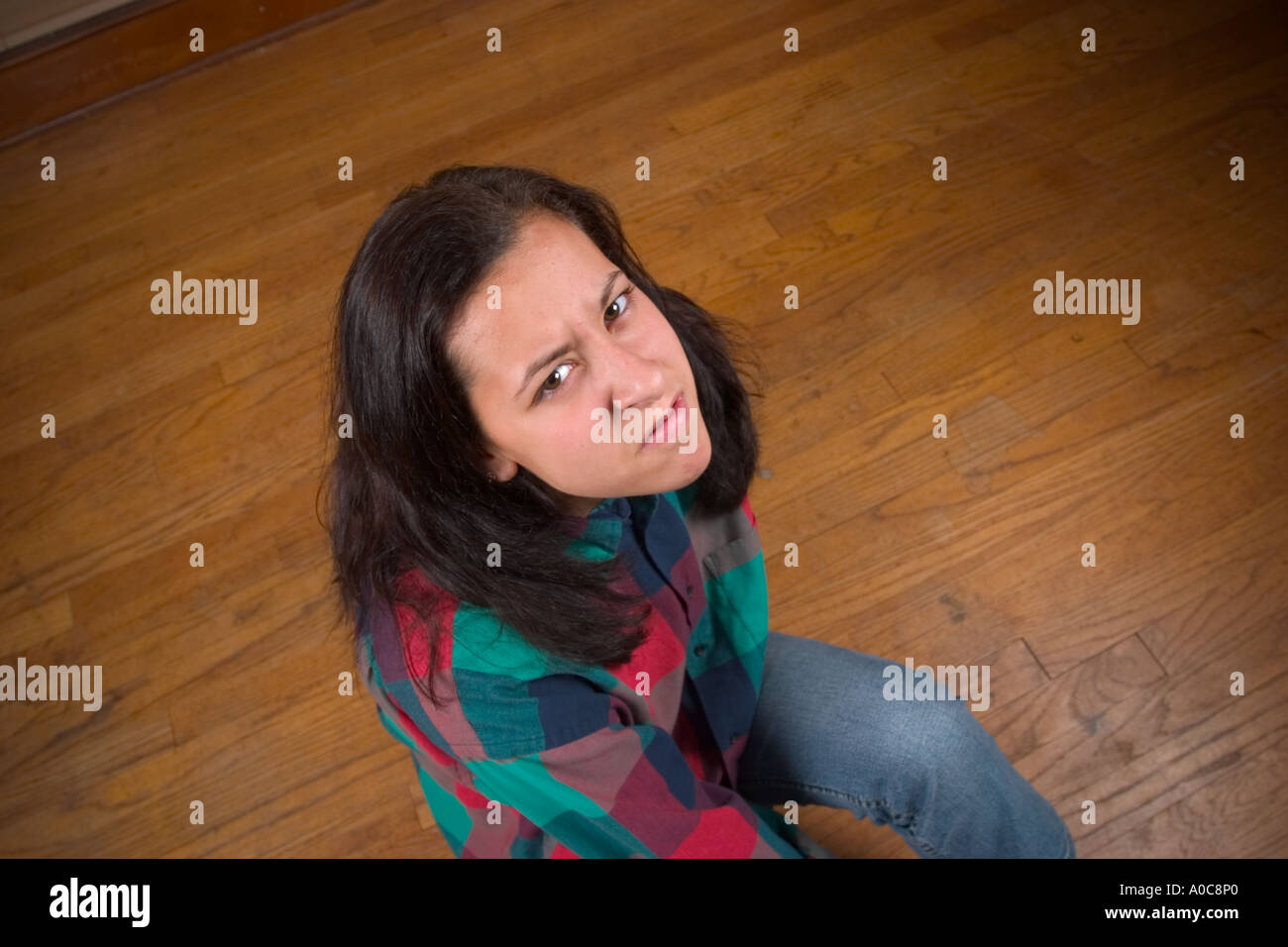 Teen girl sitting on the floor Model Released Stock Photo - Alamy