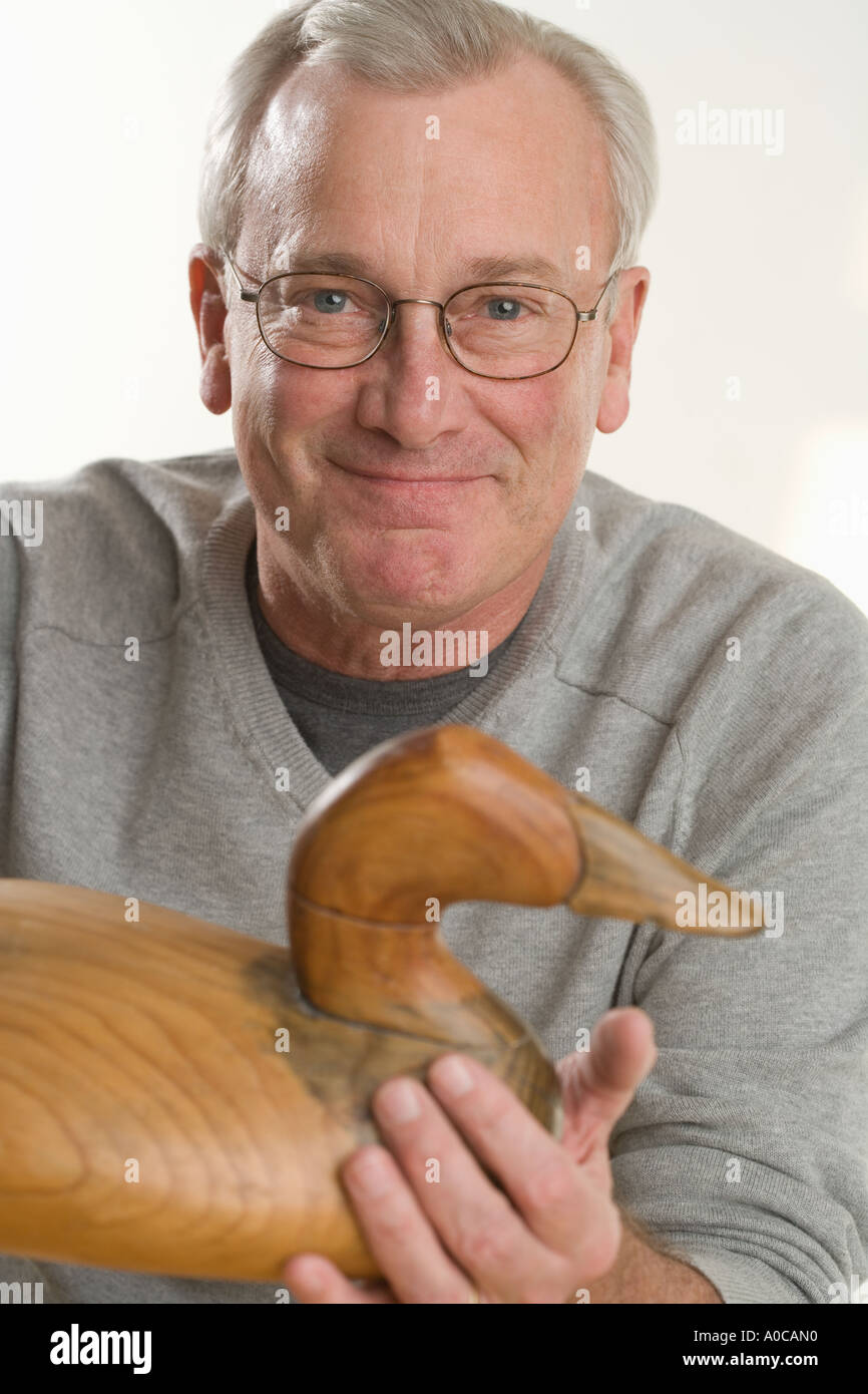 Man holding handmade wooden duck Stock Photo - Alamy
