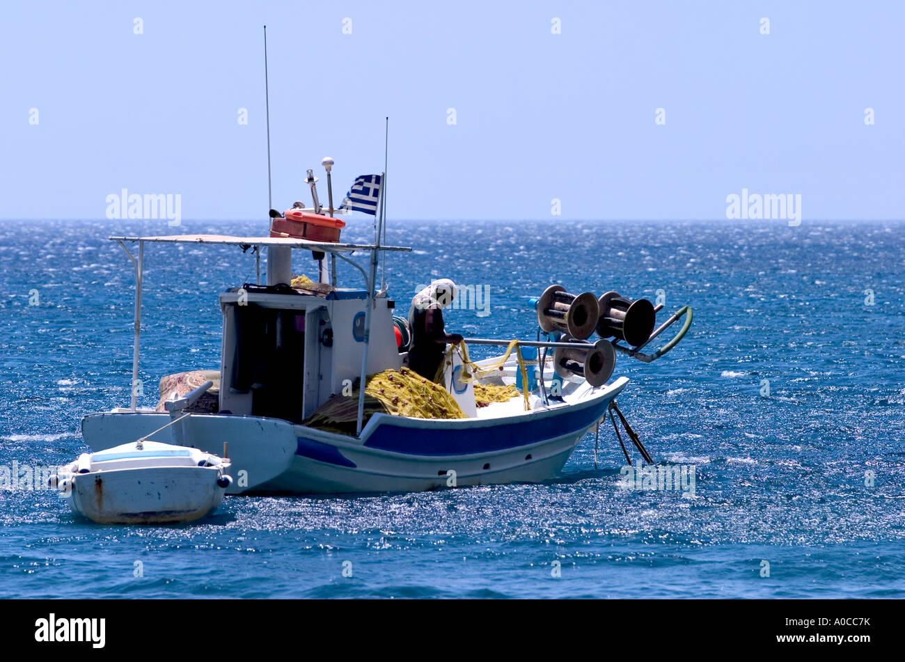 fishing rowing with fisher man inside preparing fishnet cos kos islands dodecanese greece Stock Photo