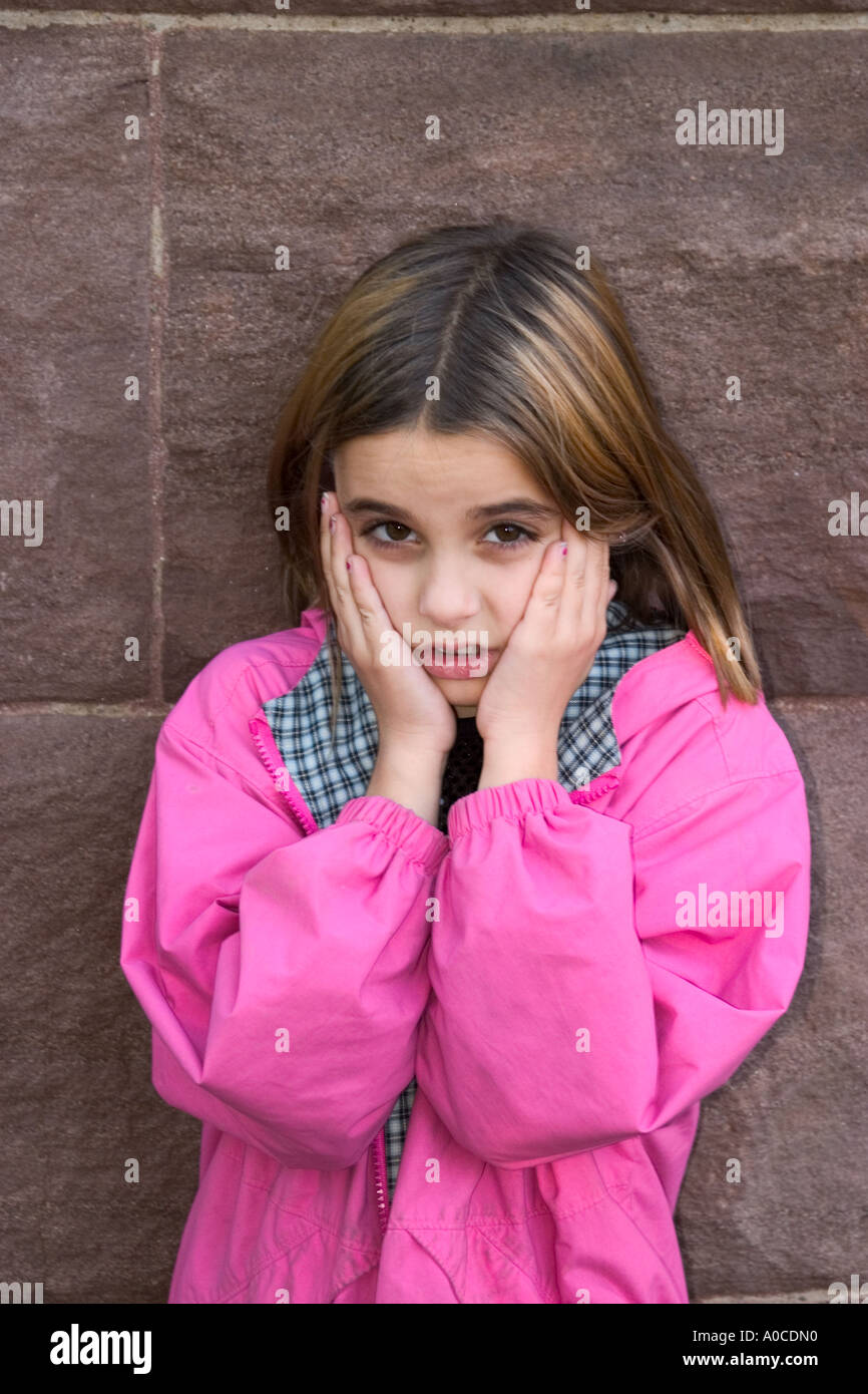 Young girl with her hands on her face Stock Photo - Alamy