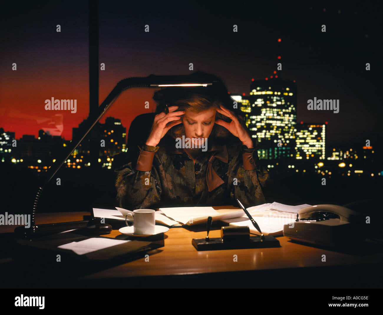 Woman Executive working late in her office, with maybe stress, headache