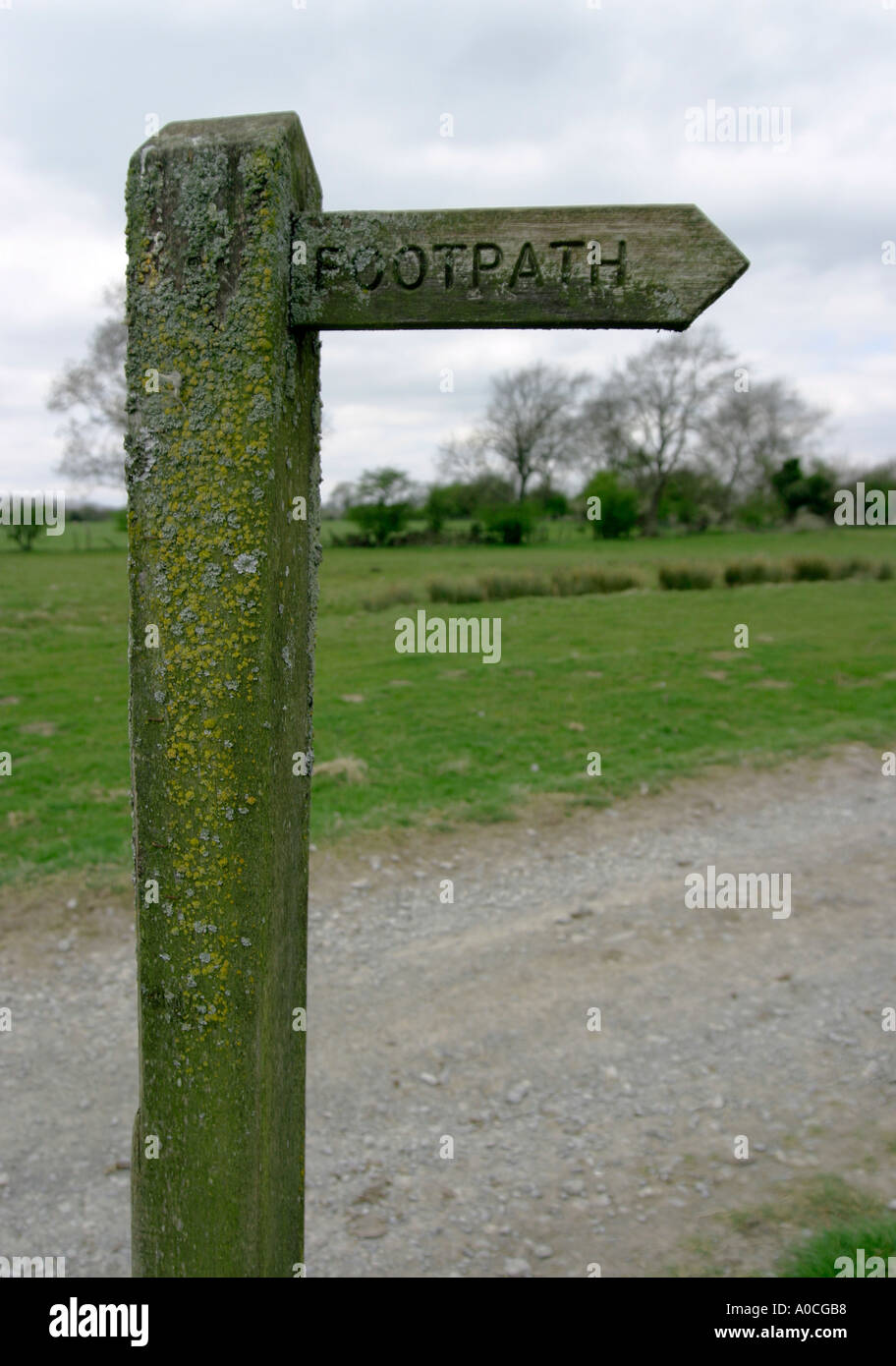 Public Footpath Sign covered in moss Stock Photo