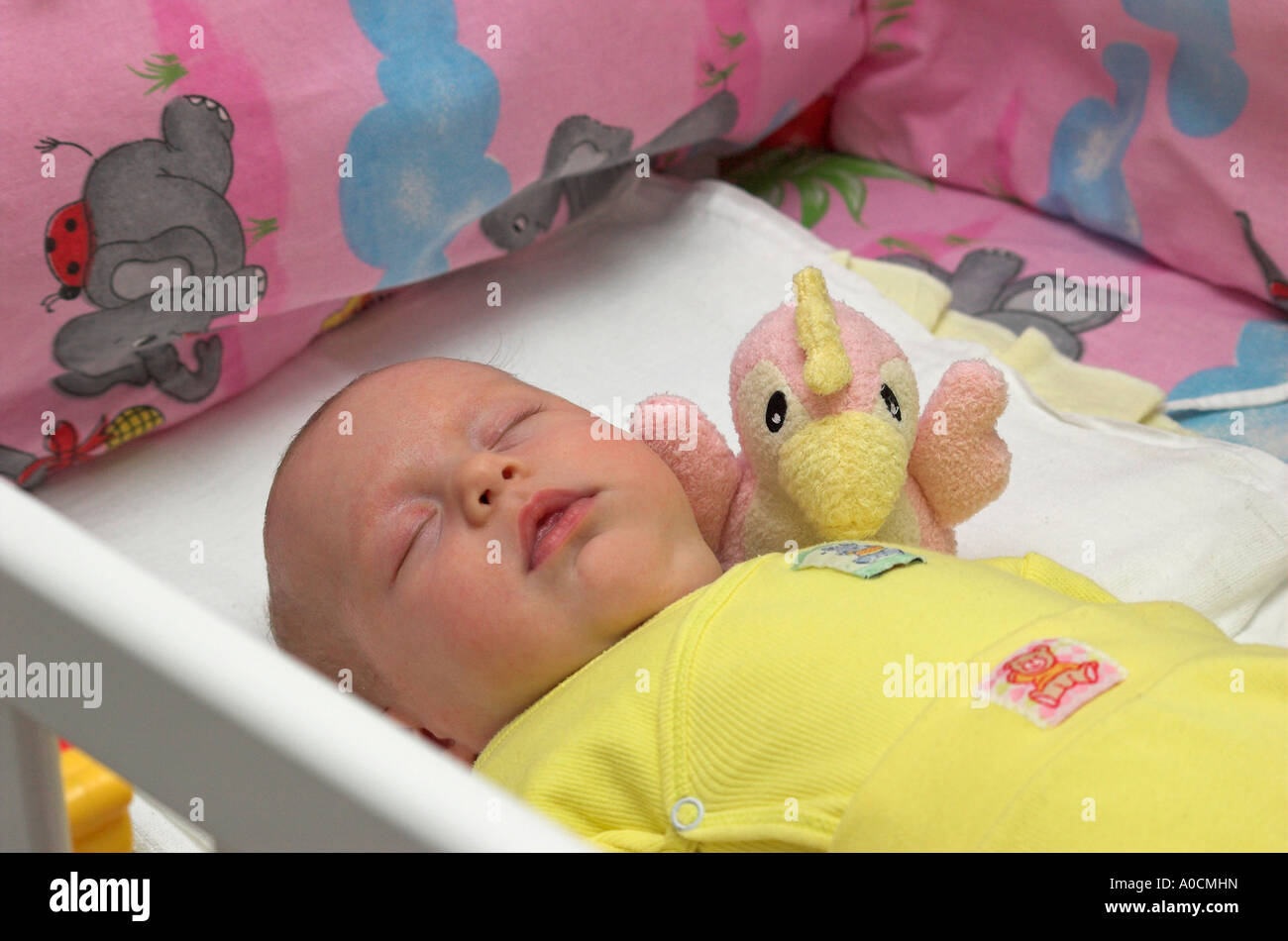 Baby girl lying in cot hi-res stock photography and images - Alamy
