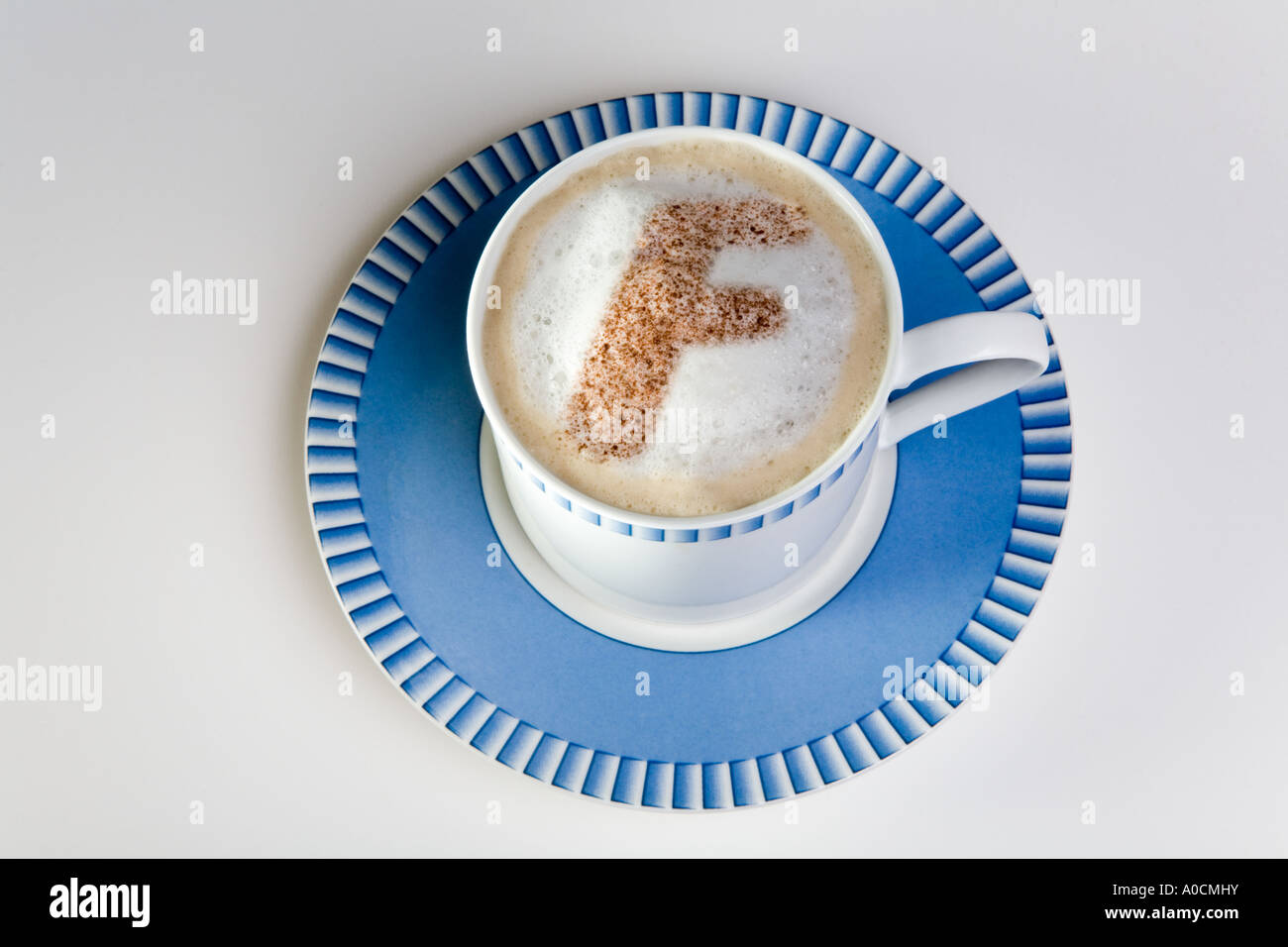 letter f in froth of cup of hot cappuccino coffee Stock Photo