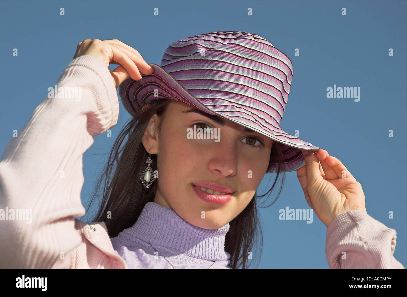Young woman outdoors wearing hat Stock Photo
