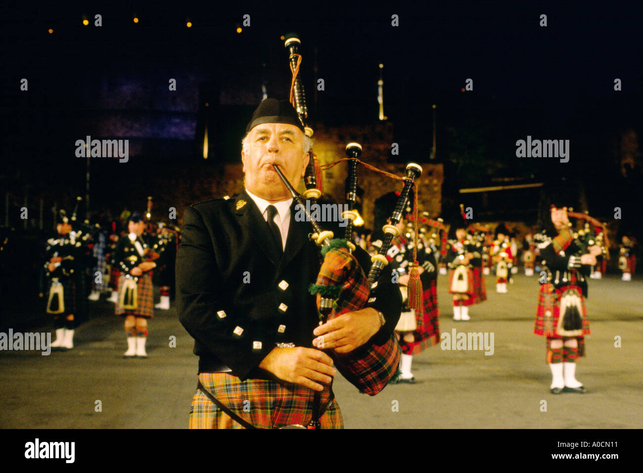 Piper playing Scottish bagpipes on esplanade of Edinburgh Castle at annual Edinburgh Military Tattoo, Scotland, UK Stock Photo