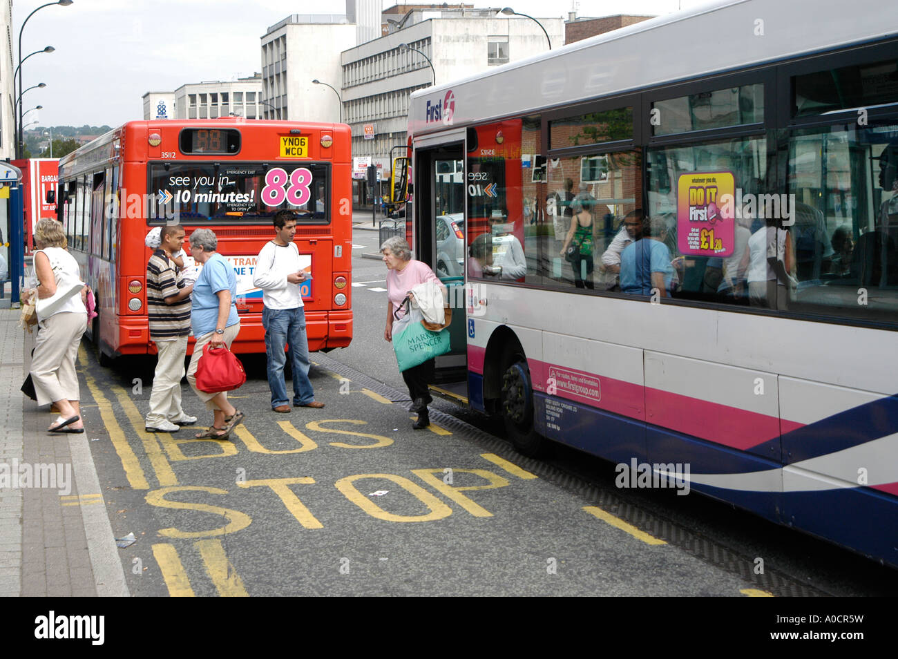 Passengers getting off a bus in Firstbus livery in Sheffield city centre. Stock Photo