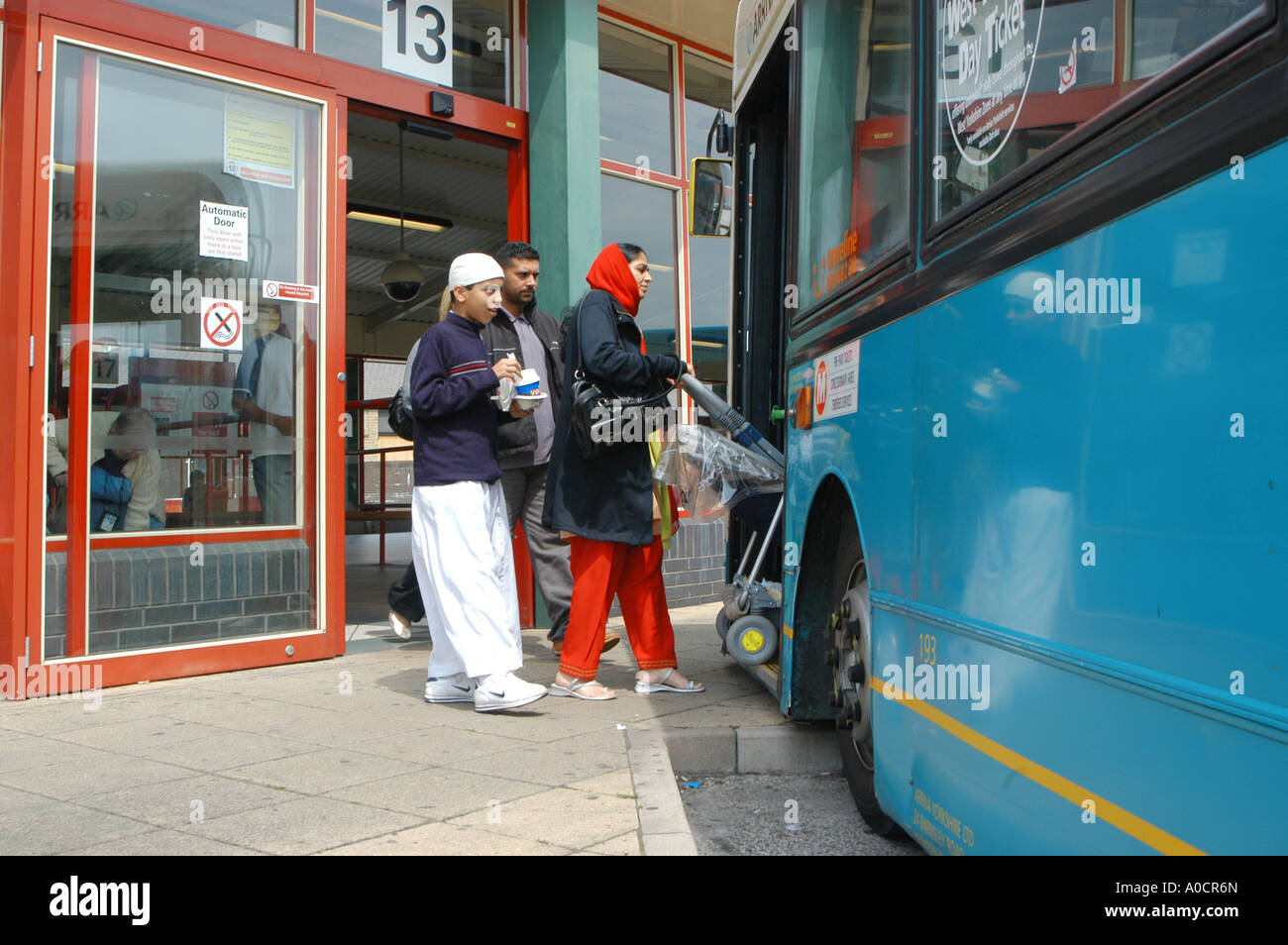 Passengers boarding an arriva bus in Dewsbury, England Stock Photo