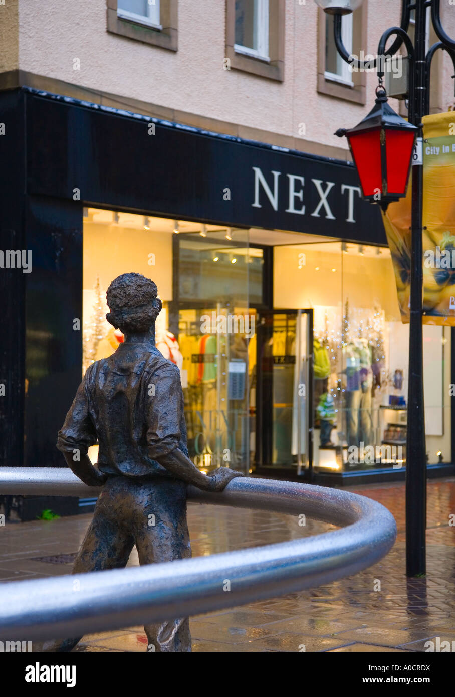 'Nae Day Sae Dark' in pensive man in Perth city centre, public art steel ring statue, Christmas decorations and festive street lighting Perthshire UK Stock Photo