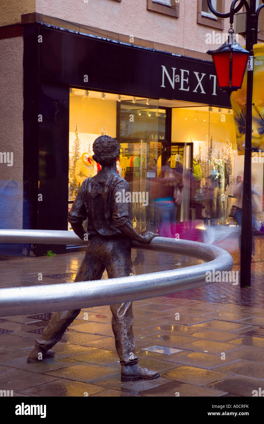 'Nae Day Sae Dark' in pensive man in Perth city centre, public art steel ring statue, Christmas decorations and festive street lighting Perthshire UK Stock Photo
