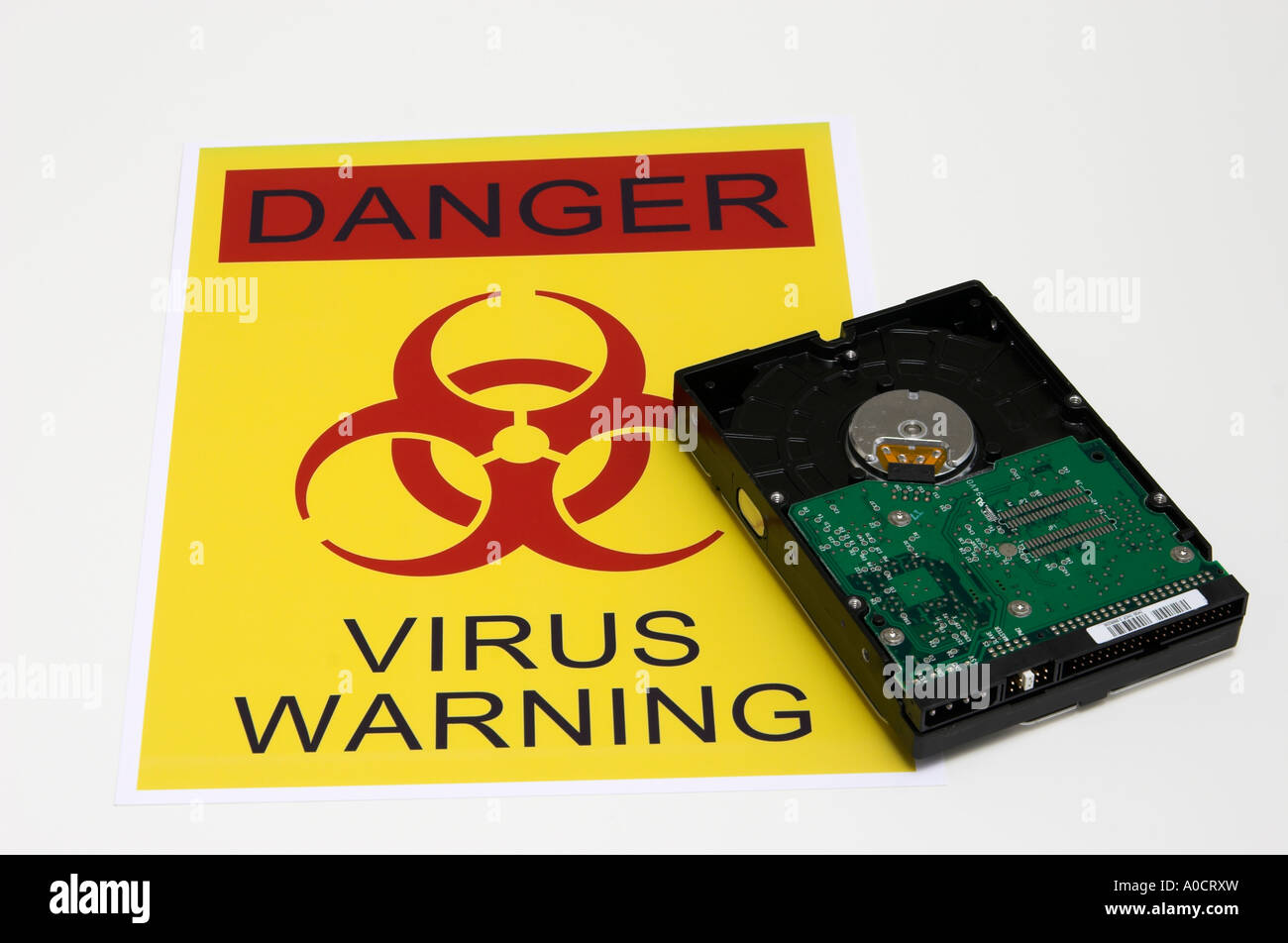 Computer hard drive on the virus warning sign. All logos removed Stock